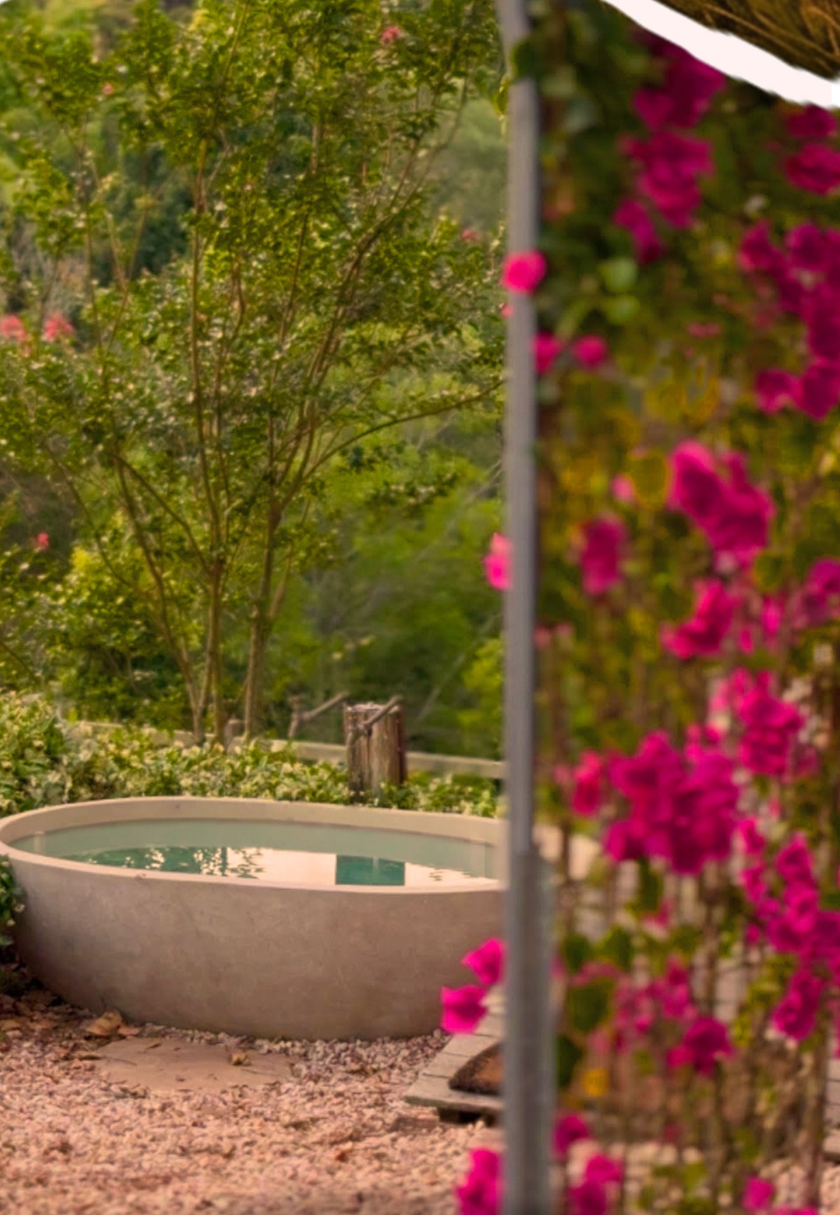 Luxury outdoor bath surrounded by pink bougainvillea